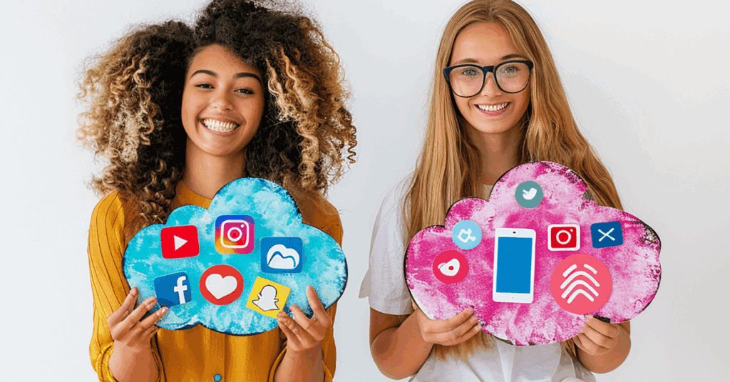 Two women hold up cloud shaped art pieces featuring icons from some of the best digital ad platforms for businesses, including YouTube, Instagram, and Facebook.