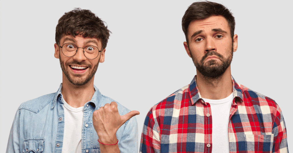 A happy man in glasses and a denim shirt points to a frowning man in a plaid shirt, demonstrating the difference between a business that has a crisis-proof digital marketing strategy during economic shifts and one that does not.