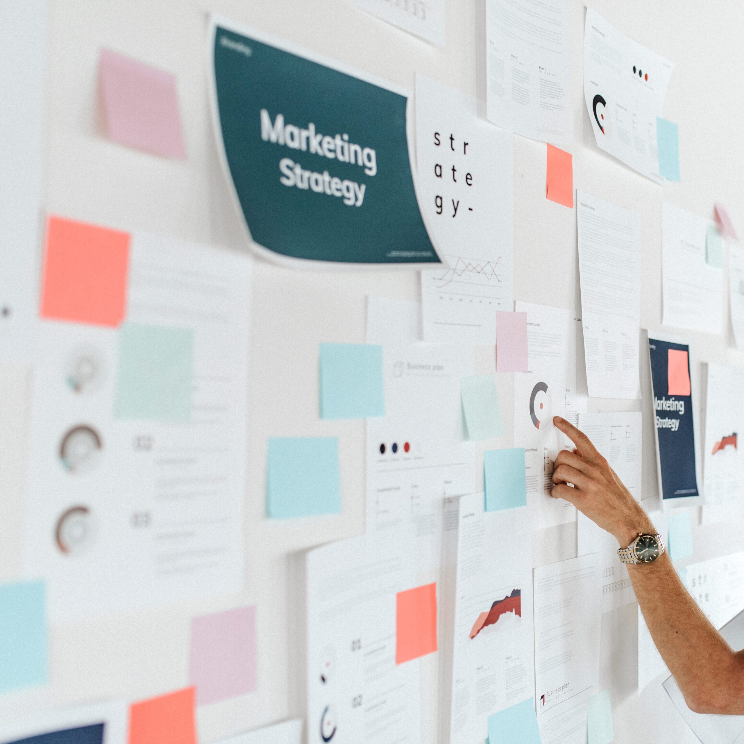 A man looking at a board full of papers about martech stack audits, HIPAA-compliant marketing, AI, and digital marketing consulting services.